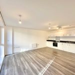 Modern open-plan kitchen with hardwood flooring.