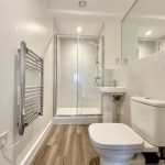 Modern bathroom with shower and toilet.