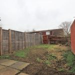 Empty garden with wooden and brick fences