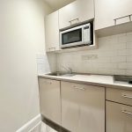 Modern kitchen with microwave and electric hob.