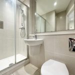 Modern bathroom with shower, sink, and mirror