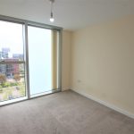 Empty room with window and city view