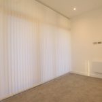 Empty room with beige carpet and white blinds