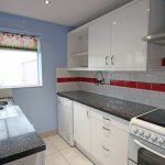 Modern kitchen with white cabinets and tiled backsplash