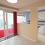 Kitchen with red accents and glass doors