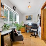 Bright home office with desk and chair.
