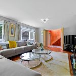 Modern living room with grey sofa and fireplace.