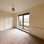 Empty room with balcony and wardrobe.