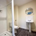 Modern bathroom with shower and sink.