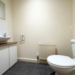 Modern bathroom with sink and toilet.