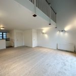 Spacious loft-style apartment with modern lighting.