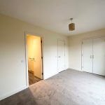 Empty room with beige walls and carpet