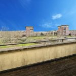 Modern building with spacious balcony and clear blue sky.