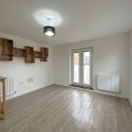 Bright room with wooden floor and wooden shelves.