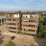Aerial view of office building with parking spaces.