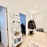 Modern hallway with shelves, coat rack, and shoes