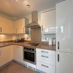 Modern kitchen with cream cabinets and appliances