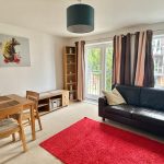Modern living room with dining table and sofa.