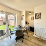 Modern dining area with garden view.