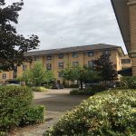 Residential building with cars and greenery