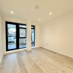 Empty room with wooden floor and large window