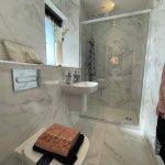 Modern marble bathroom with shower and sink