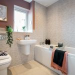 Modern bathroom with bath, sink, and toilet.