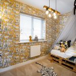 Children's room with safari animal wallpaper decor.