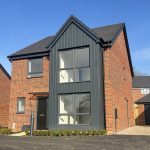 Modern brick house with large windows.