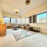 Bright living room with corner sofa and windows