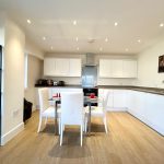 Modern kitchen with dining table and chairs