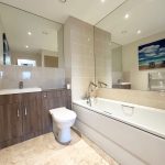 Modern bathroom with bathtub and artwork