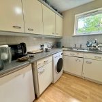 Compact kitchen with appliances and window view