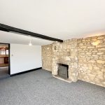 Stone fireplace in cosy modern room with doorway.