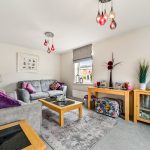 Cosy living room with modern decor and sofas.