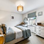 Cosy bedroom with double bed and dresser