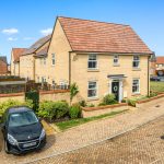 Modern two-storey brick house with front garden.