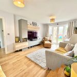 Modern living room with grey sofa and wooden floor
