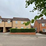 Modern UK house with brick facade and driveway.