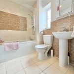 Modern bathroom with bath, toilet, and sink