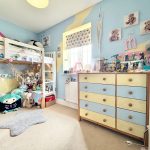 Colourful child's bedroom with toys and bunk bed.