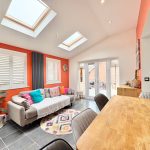 Bright living room with skylights and colourful decor.
