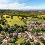 Aerial view of countryside and village homes.