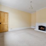 Empty room with fireplace and wooden door