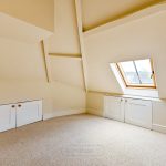 Loft room with skylight and storage cupboards.