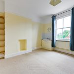 Unfurnished room with sink, shelves, and window