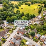 Aerial view of countryside houses for sale.