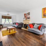 Bright living room with sofas and fireplace.