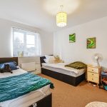 Cosy twin bedroom with colourful decor.