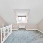 Empty loft room with window and railing